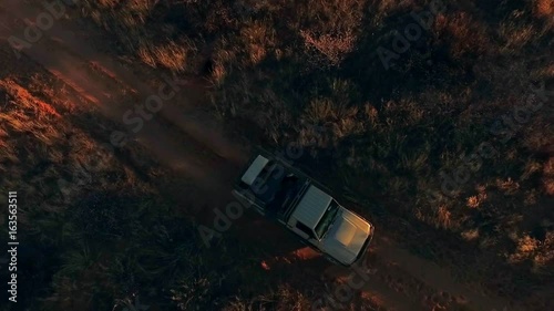 A hunting off-road car rides in the savannah.