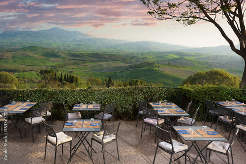 view from the restaurant on the Tuscan field at sunset.