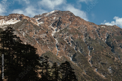 Brown mountain with snow on the top is background at Thangu and Chopta valley in winter in Lachen. North Sikkim, India. photo