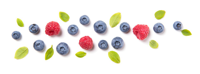 Fresh blueberries with leaves and raspberries, berry ornament isolated on white background, top view