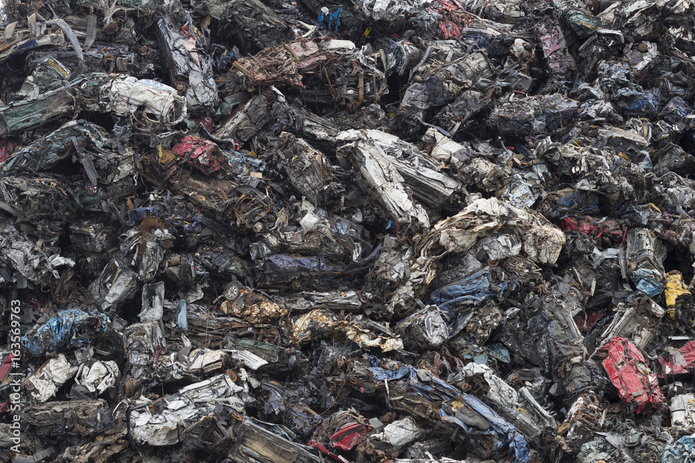 Background image of mountain of scraps cars.