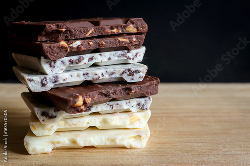 chocolate bar stack on wooden background.