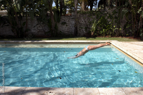 Girl diving in pool