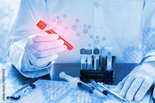 Double exposure of close up of DNA testing of the blood in the laboratory with Doctor , medical research, mixs of medical ampoules and syringe and development concept.(blue tone)
