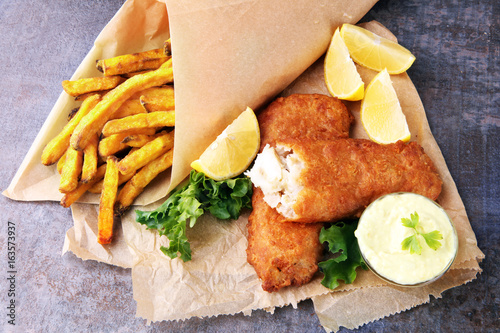 Photography traditional British fish and chips on brown paper