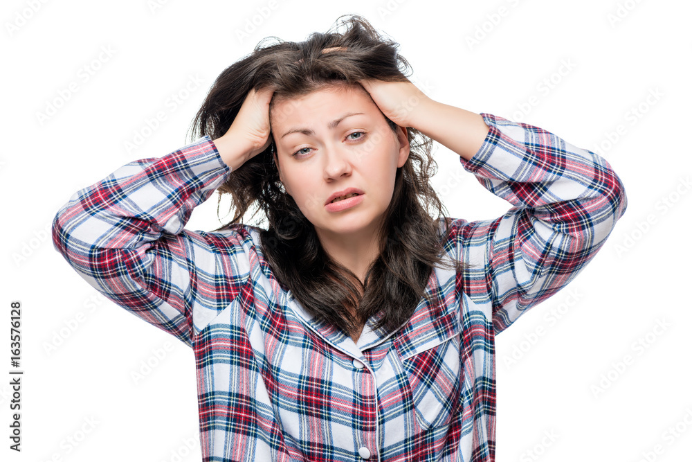 Sleepy unhappy woman in pajamas on a white background isolated