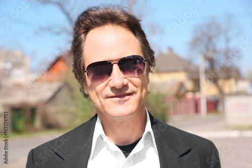 Portrait of mature man wearing sunglasses outdoor