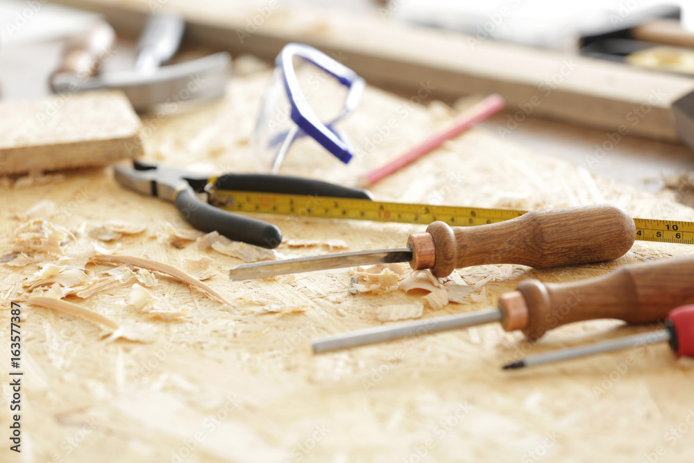 Naklejka premium Table with tools in carpenter's workshop, closeup