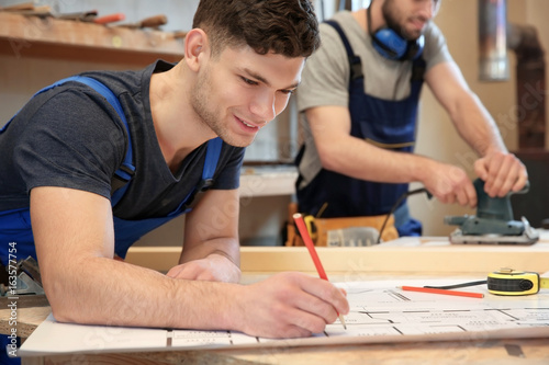 Young carpenters working in...