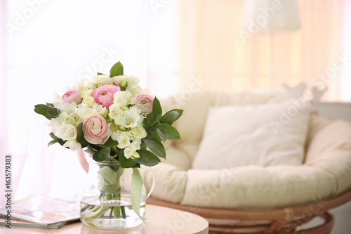 Beautiful bouquet with white freesia on table at home