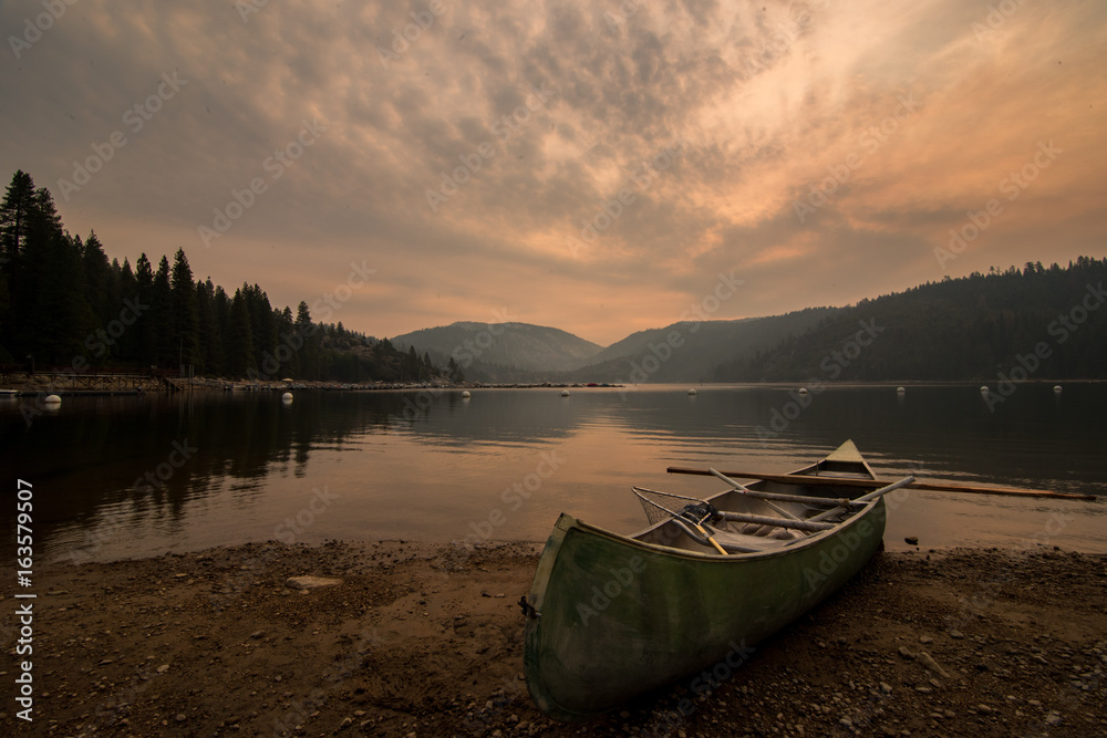 Canoe and paddle on shore of Pinecrest Lake in California 