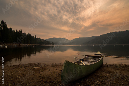 Canoe and paddle on shore of Pinecrest Lake in California © Melissa Masinter