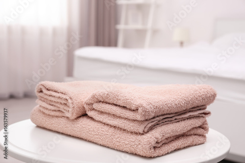 Clean towels on the table in room © Africa Studio