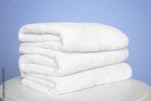 Stack of clean white towels on table