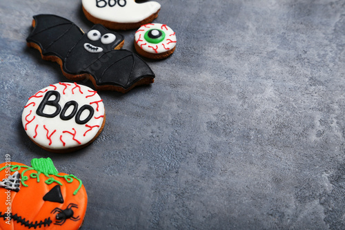 Fresh halloween gingerbread cookies on grey wooden table