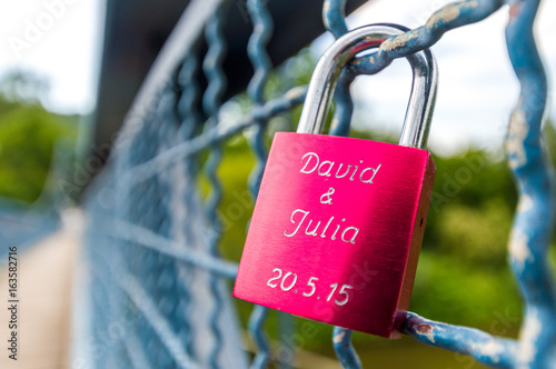 Red love lock on the bridge