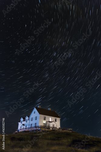 Night sky, star Trails over an old fish Merchants residence, Cange Islands, Newfoundland & Labrador