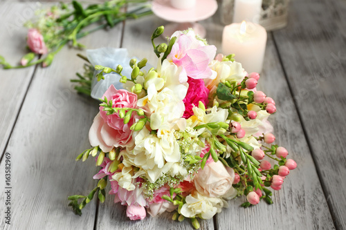 Beautiful bouquet with freesia flowers on table