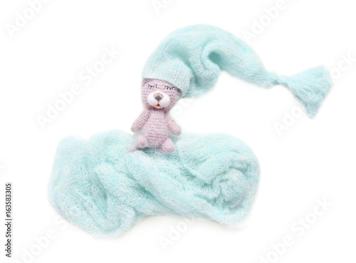 Adorable toy made in crochet and baby clothes in shape of cloud isolated on white © Africa Studio