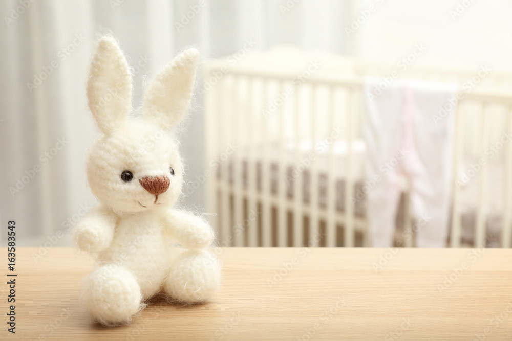Cute crochet bunny baby toy on table in bedroom Cute crochet bunny baby toy on table in bedroom