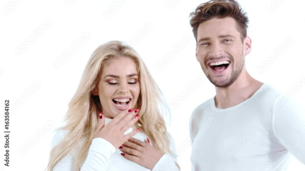 Sexy young couple posing on studio background, 4k slow motion studio clip Sexy young couple posing on studio background, 4k slow motion studio clip