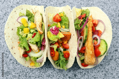 Delicious fish tacos on table