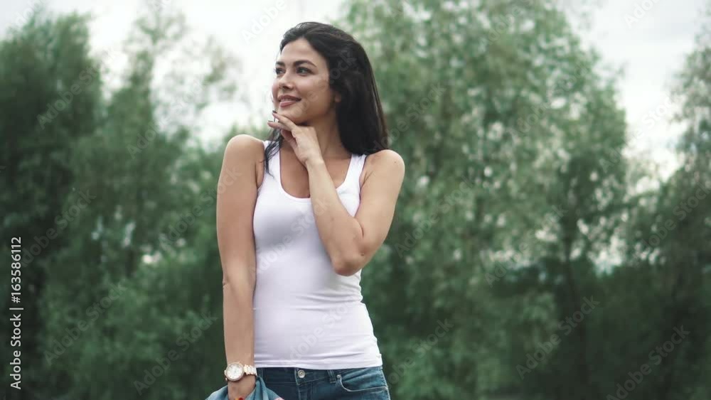 beautiful girl in summer clothes walks in the Park beautiful girl in summer clothes walks in the Park