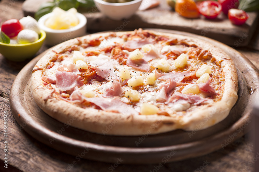 Pizza with a topping of Ham and Pineapple