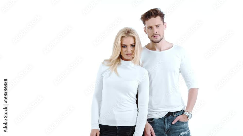 Sexy young couple posing on studio background, 4k slow motion studio clip Sexy young couple posing on studio background, 4k slow motion studio clip