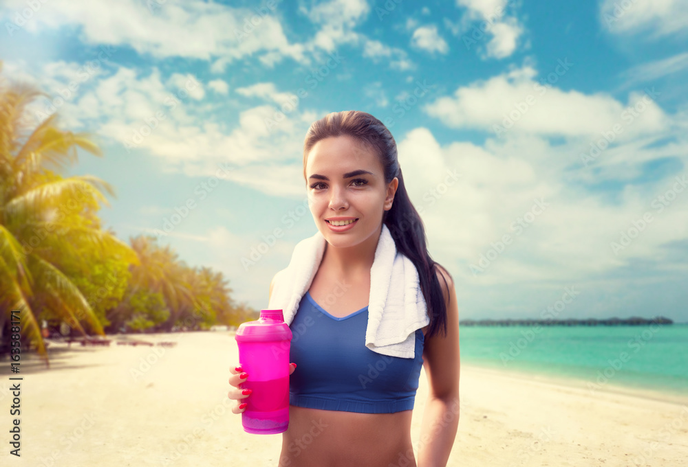 Young woman with sport bottle on seaside Young woman with sport bottle on seaside