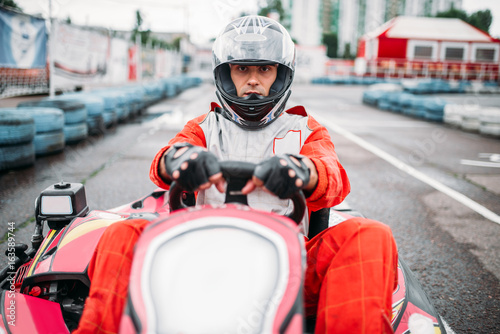 Karting race, go cart driver in helmet