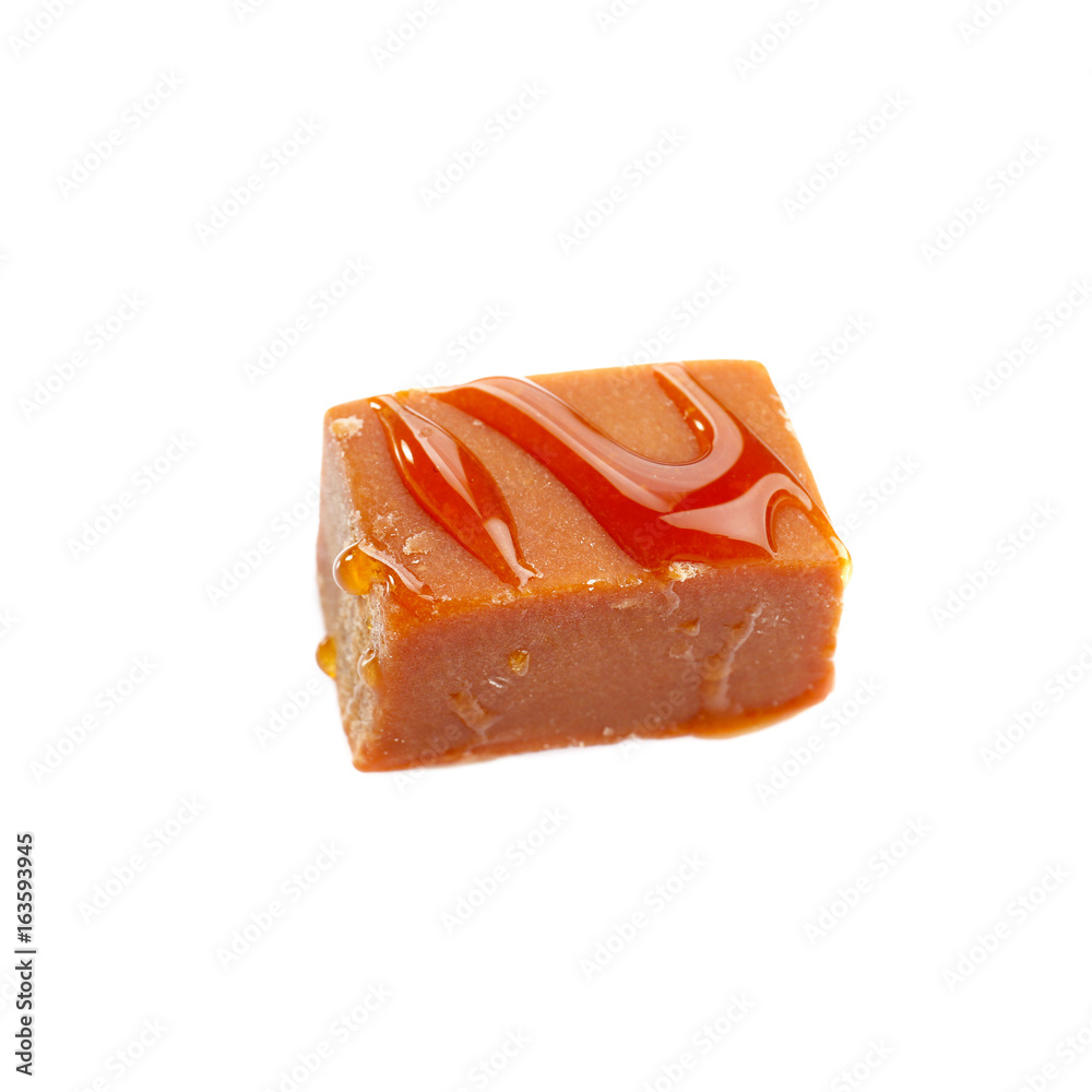 Tasty caramel sauce with candy on white background Tasty caramel sauce with candy on white background
