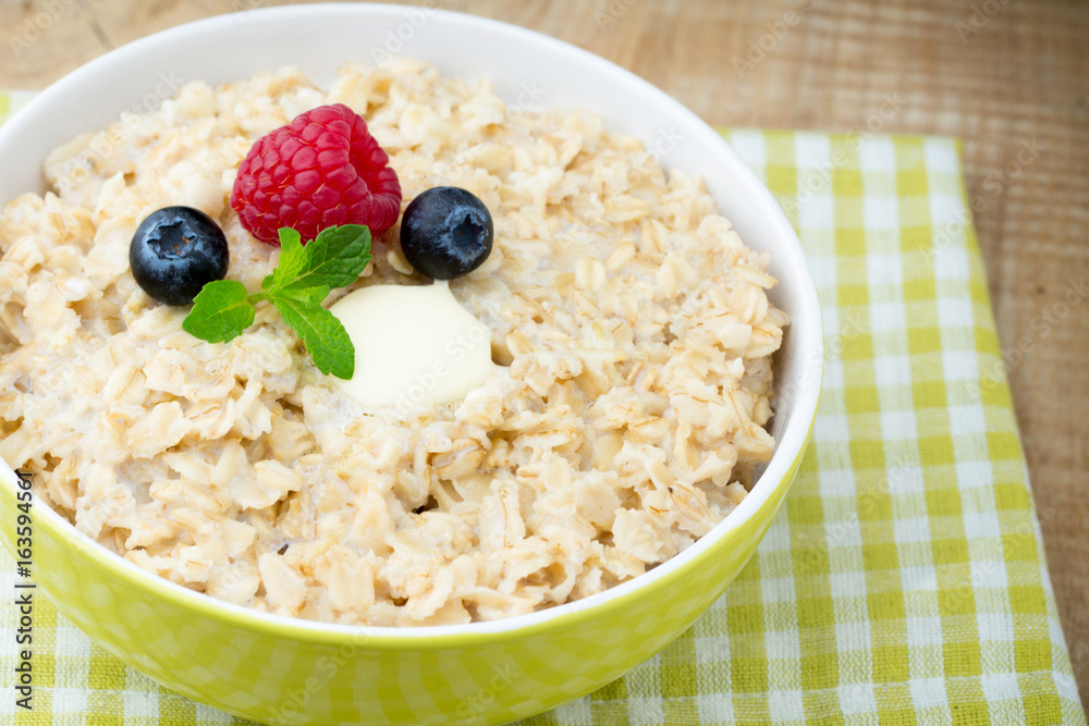 Oatmeal porridge in bowl with berries raspberries and blackberries. Oatmeal porridge in bowl with berries raspberries and blackberries.