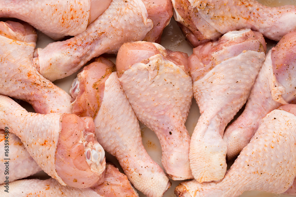 Fresh chicken leg, meat on plate.With spices. Fresh chicken leg, meat on plate.With spices.