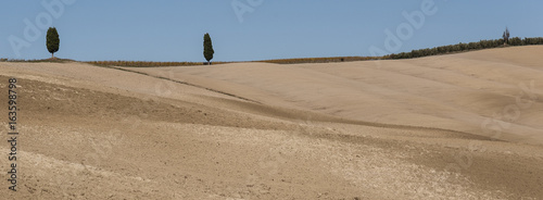 SAN QUIRICO D'ORCIA, TUSCANY / ITALY - OCTOBER 31, 2016: Beautiful tuscan landscape near San Quirico d'Orcia, with rolling hills and tuscan cypress trees. Located in Val D'Orcia countryside - Italy.