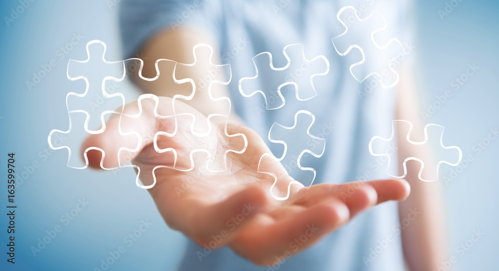 Businessman holding hand-drawn puzzle pieces Businessman holding hand-drawn puzzle pieces