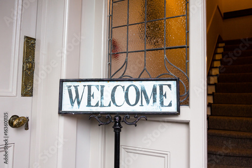 Vintage welcome message at etrance into old home photo