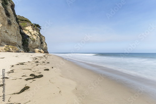 Secluded Dume Cove beach with motion blur water near Los Angeles in Malibu, California.