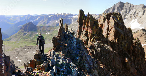 Man hiking to the summit on a 14er mountain in Colorado photo
