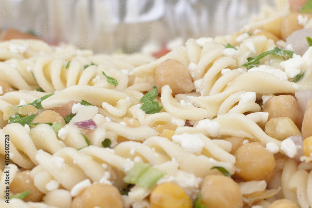 a close or macro view of fusilli or spiral pasta, food in a dish with chickpeas a close or macro view of fusilli or spiral pasta, food in a dish with chickpeas