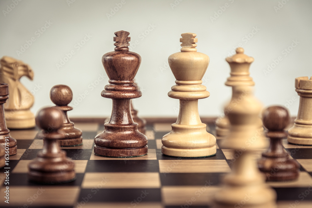 Chess on board white backgroung. Confrontation concept Chess on board white backgroung. Confrontation concept