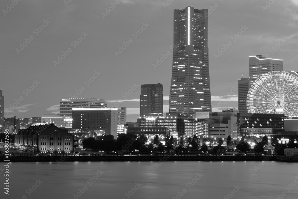 Urban Landscape of Yokohama, Japan with moving colorful clouds in monochrome