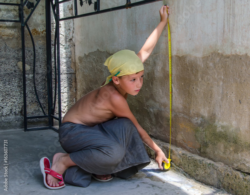 teenager measuring a wall