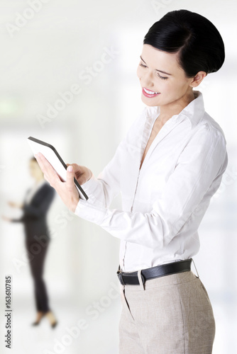  Business woman holding tablet computer with touchpad.