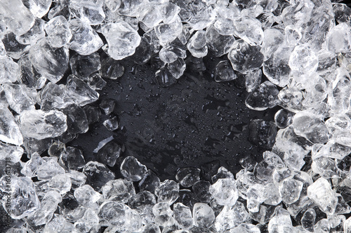 Frame of Crushed ice on black background. Copy space, top view photo