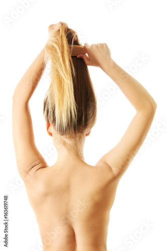 Photo of combing woman with long blond hair