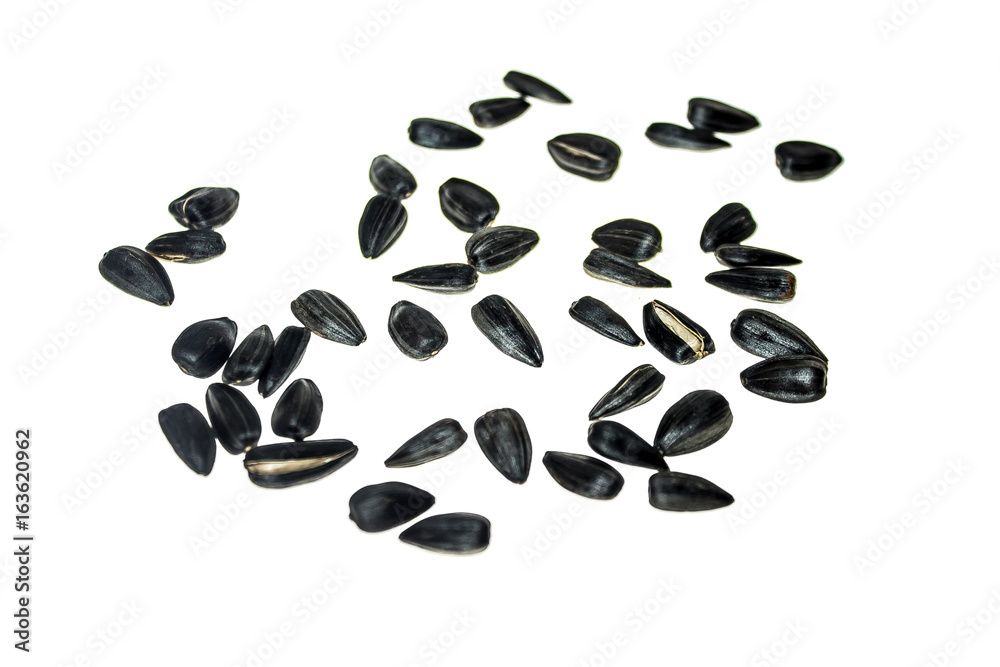 Black sunflower seeds on a white background Black sunflower seeds on a white background