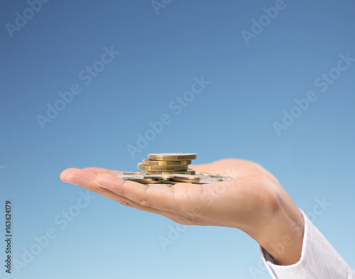human hand putting coin to money