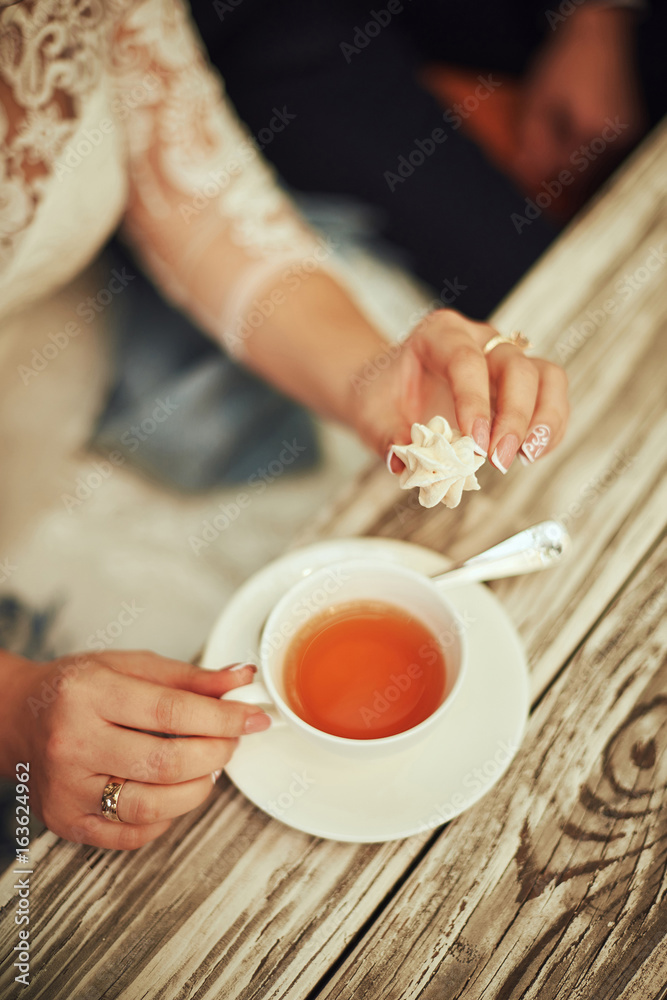 Bride and groom coffee break dating gift, bouquet on table. Bride and groom coffee break dating gift, bouquet on table.