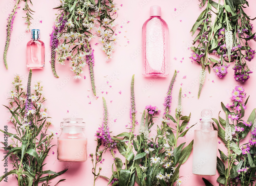 Natural cosmetic products setting with various bottles and fresh herbs and flowers on pink background, top view, flat lay. Beauty, skin, hair or body care concept - obrazy, fototapety, plakaty 